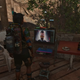 Far Cry 6 protagonist stands in front of a TV showing villains from the past games in the series.